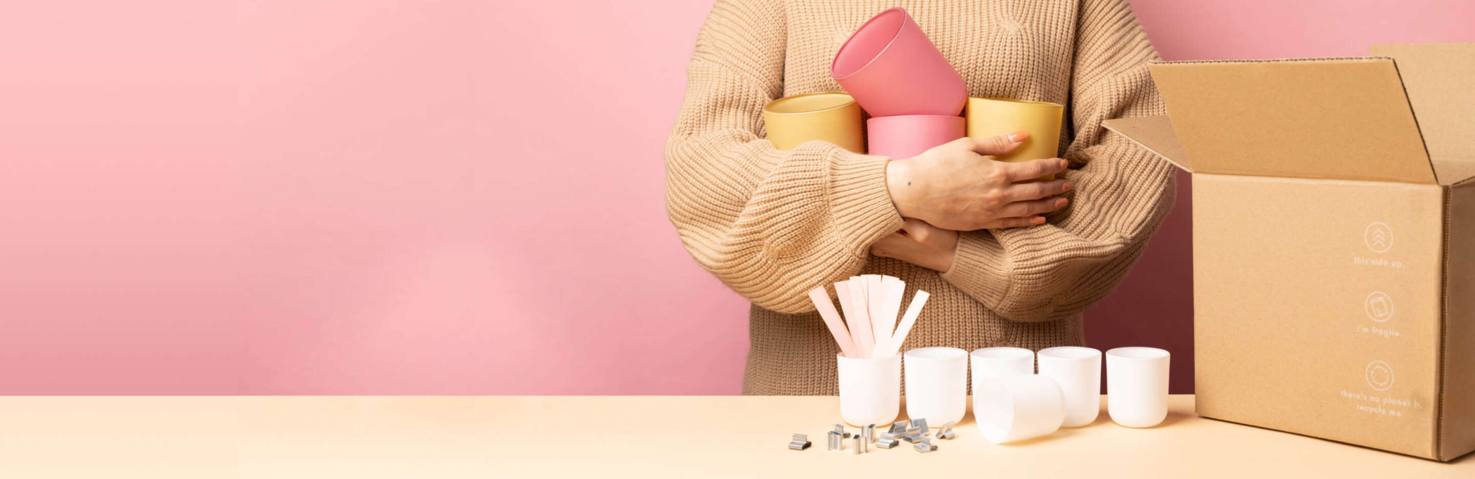 woman holding an abundance of candle vessels