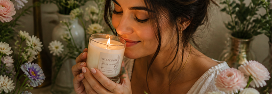 Candle maker blending premium fragrance oils with floral and fruit botanical ingredients.