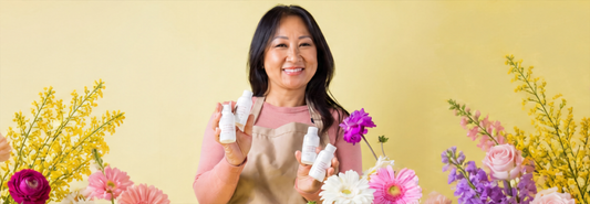 Woman holding fragrance oil ingredients to blend custom and unique candle scents.